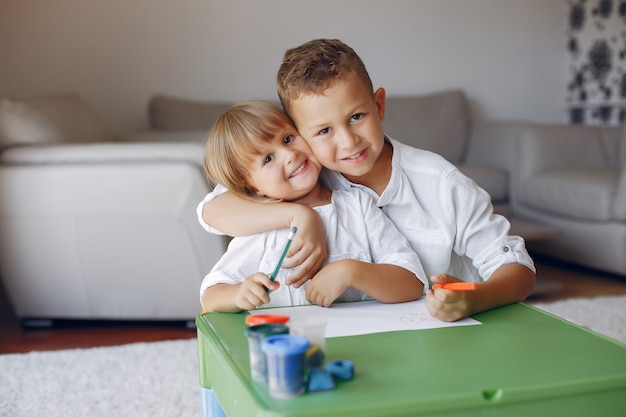 Children siting at the green table and drawing