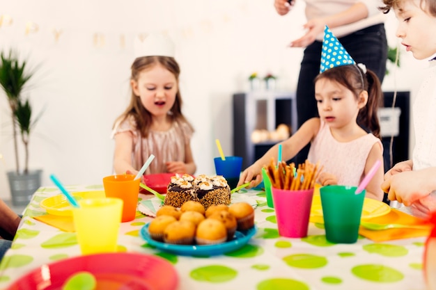 Children sitting at table on party