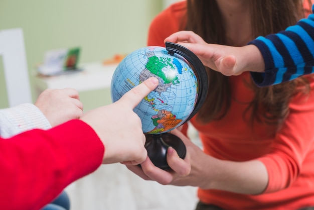 Free photo children touching globe