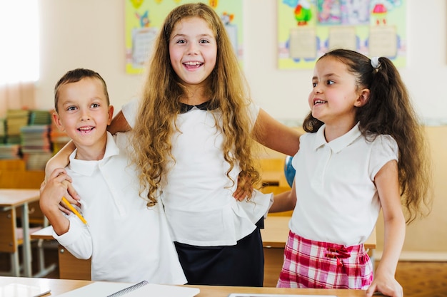 Free Photo children in white shirt hugging posing