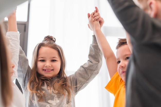 Free Photo children with their hands up