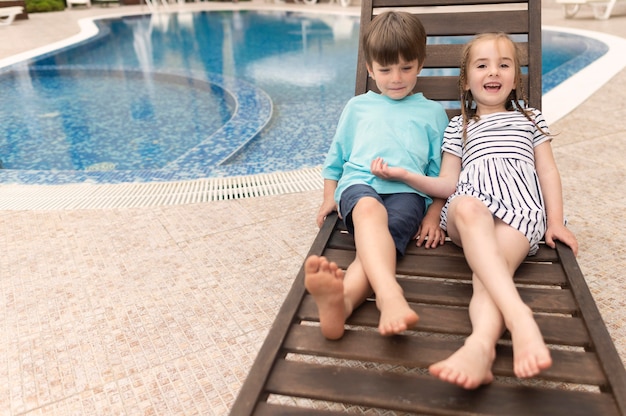 Childrens sitting on bed sun