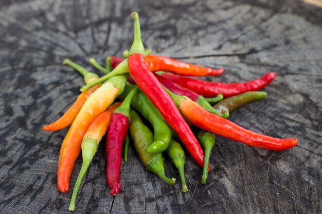 Chili peppers on wooden background