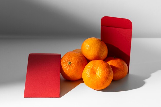 Free photo chinese new year 2021 red envelopes and oranges