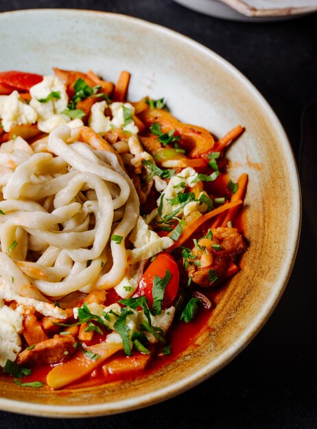 Chinese noodle soup with vegetables in tomato sauce