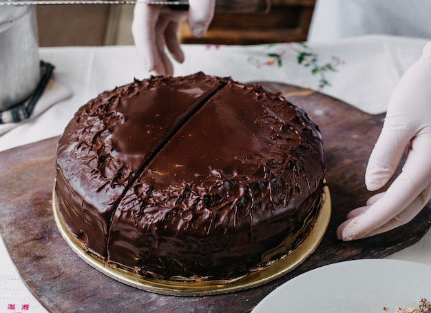 choco cake getting sliced yummy delicious round whole designing with kumquats nuts