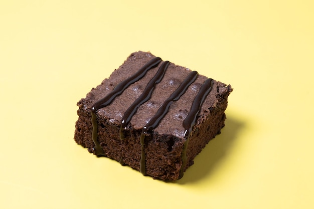 Free photo chocolate brownie portion on yellow background