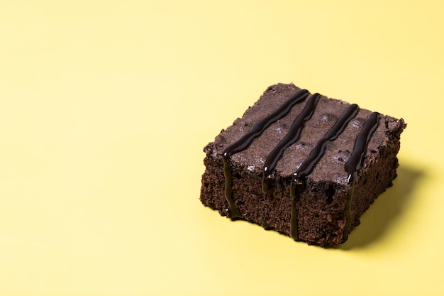 Free photo chocolate brownie portion on yellow background