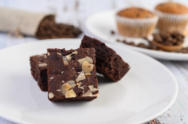 Chocolate brownies on a white plate.