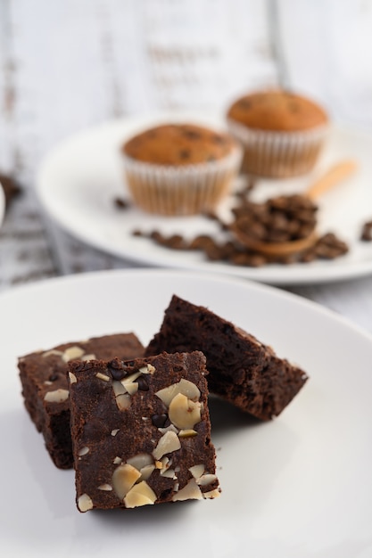 Chocolate brownies on a white plate.