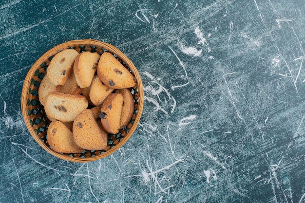 Chocolate butter crackers on blue surface.