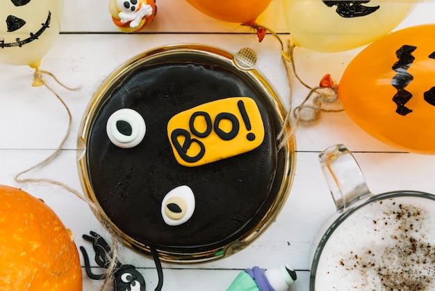 Free photo chocolate cake surrounded by halloween attributes