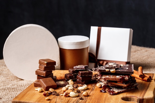 Free Photo chocolate candies cinnamon and nuts on wood desk.