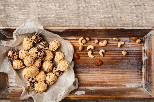 Chocolate candies and nuts on sackcloth