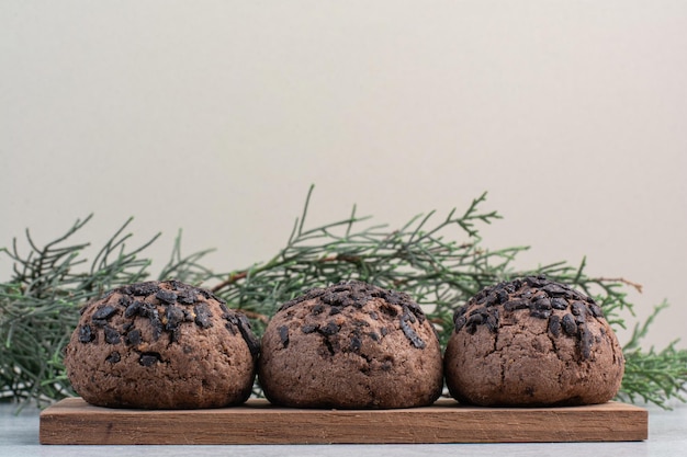 Chocolate chip cookies on wooden piece. High quality photo