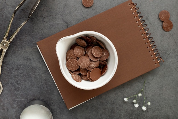 Free photo chocolate chips on a brown notebook