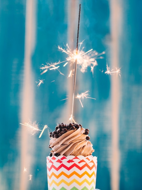 Free photo chocolate cupcake with sparkler