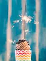 Free photo chocolate cupcake with sparkler