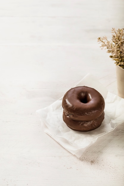 Chocolate donuts on tissue paper