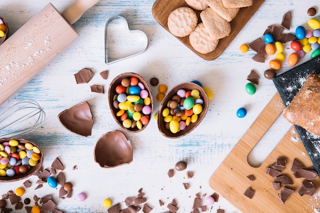 Chocolate eggs with candies near pastry