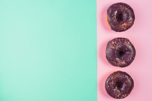 Free Photo chocolate frosted brown doughnuts decorated with sprinkles