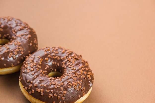 Chocolate glazed doughnuts with cocoa sprinkles