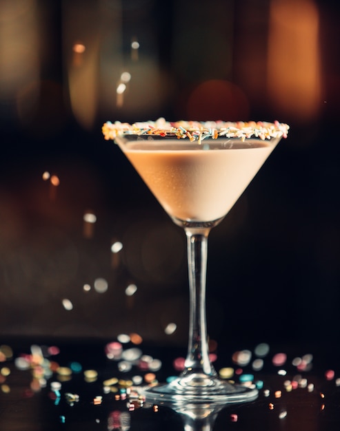 chocolate martini drink in martini glass decorated with sprinkles