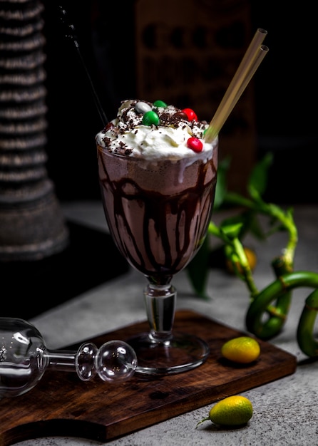 Chocolate milkshake with whipped cream and candies on top