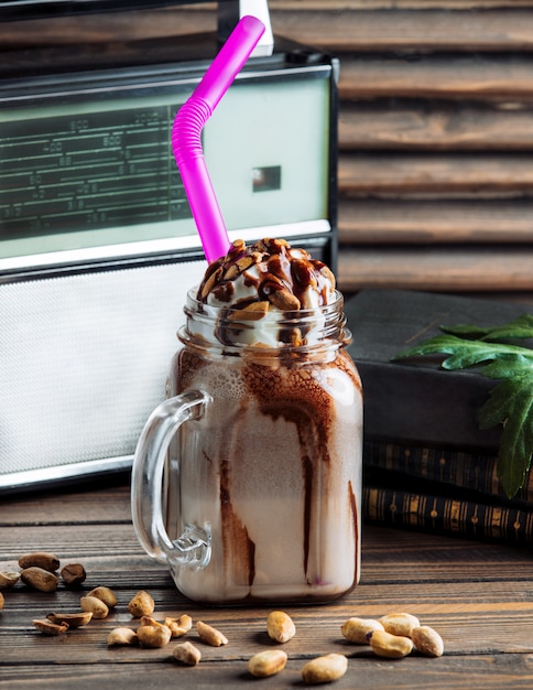 Free photo chocolate milky shake with whipping cream in a glass jar.