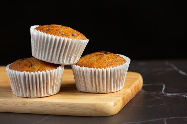 Chocolate muffins put on wooden cutting board