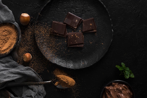 Chocolate pieces on plate flat lay