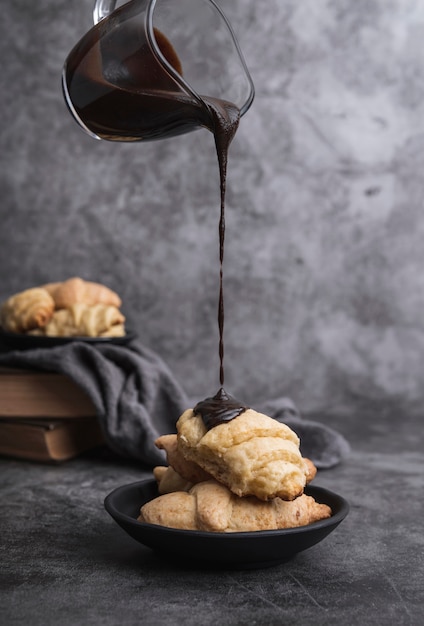 Free photo chocolate pouring on homemade croissants