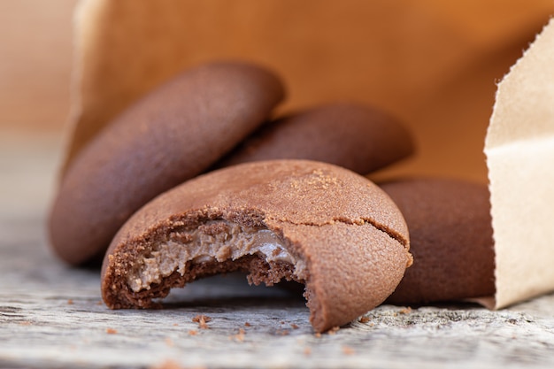 Chocolate round cookies on a wooden background