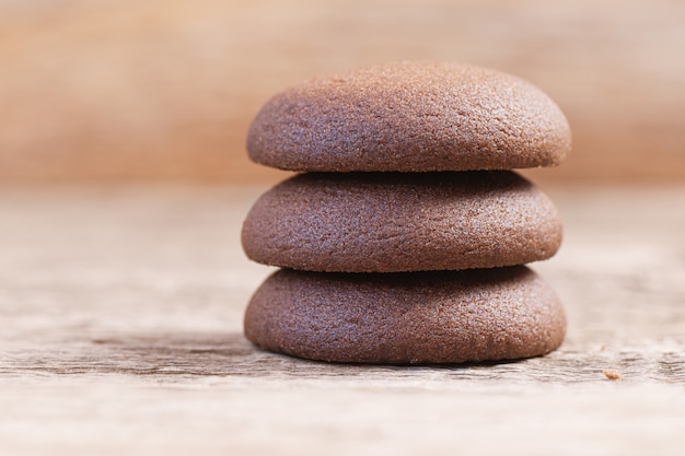 Chocolate round cookies on a wooden background