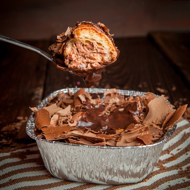 chocolate slices with spoon and cake in foil container