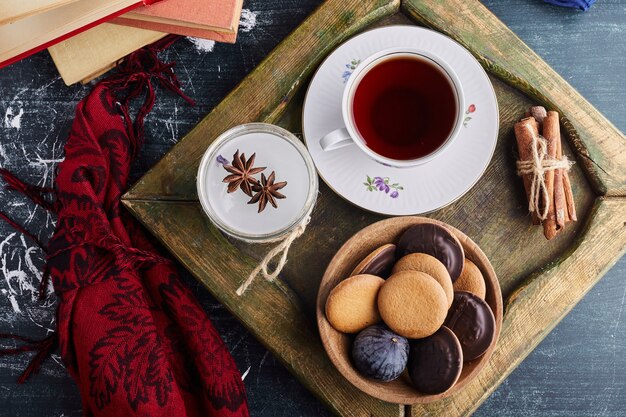 Chocolate sponge cookies with a cup of tea. 