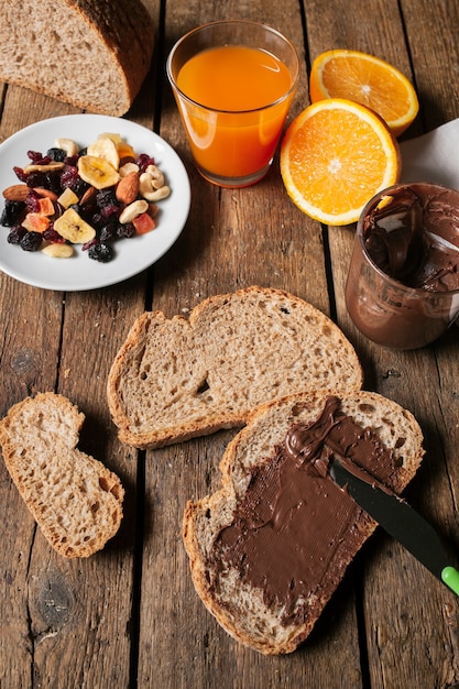 Chocolate spread on bread slice with orange juice