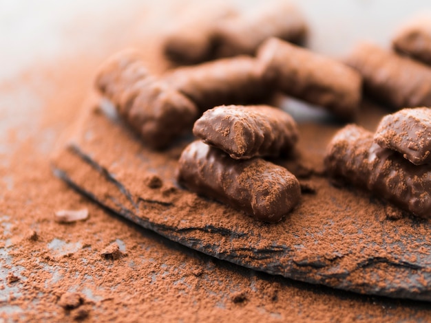 Free photo chocolate sticks covered with cocoa on slate plate