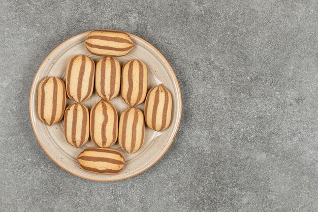 Chocolate striped biscuits on ceramic plate