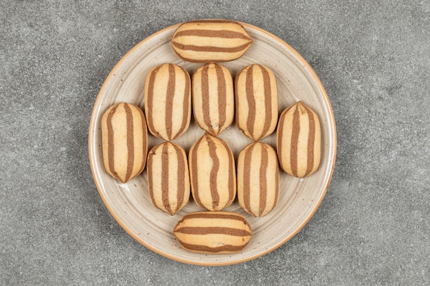 Chocolate striped biscuits on ceramic plate