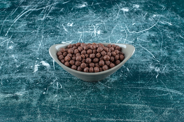 Free Photo chocolate sweet corn balls in a bowl , on the blue table. 