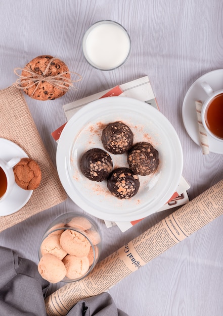 Chocolate, sweet snacks and tea on the table