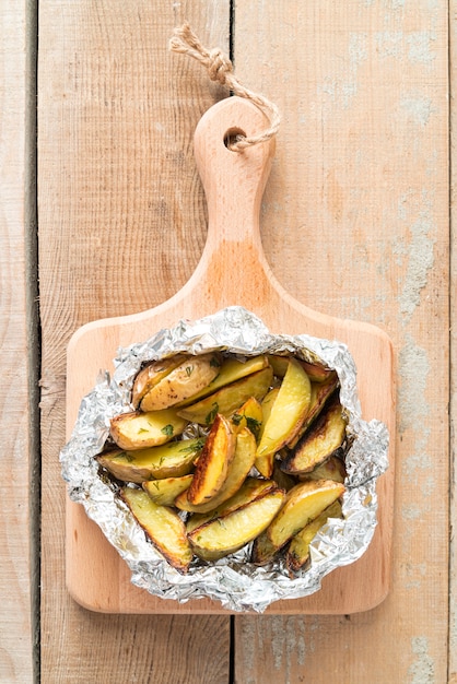 Chopped cooked potatoes on wooden board