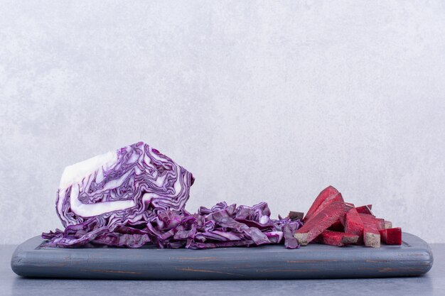 Chopped purple cabbage on a wooden platter.