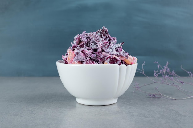 Chopped purple onion and cabbage salad in ceramic cups.