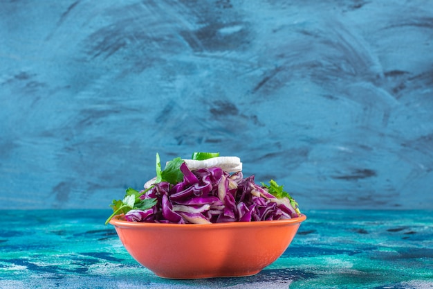 Free Photo chopped red cabbage, parsley and radish in a bowl 