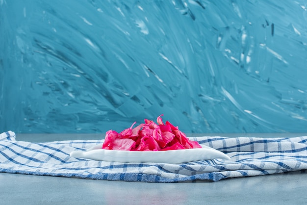 Free Photo chopped red fermented sauerkraut in a bowl on a trivet , on the blue table. 