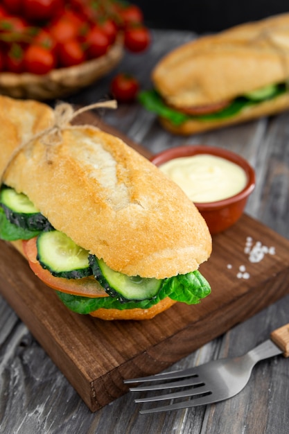 Chopping board with sandwich and mayo