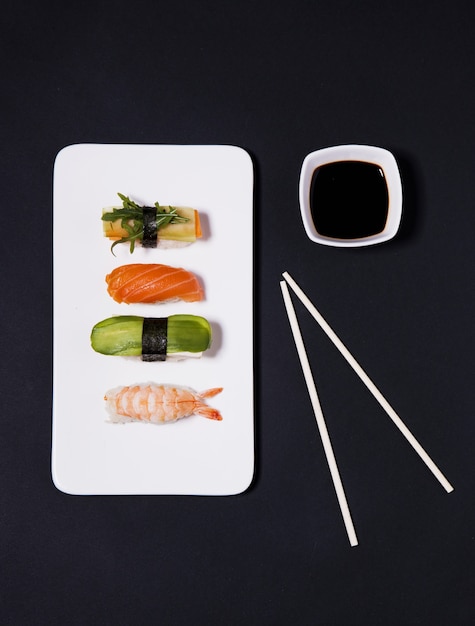 Free photo chopsticks near soy sauce and sushi