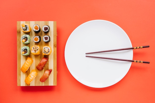 Chopsticks and plate near sushi